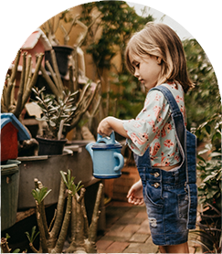 child volunteering watering plants